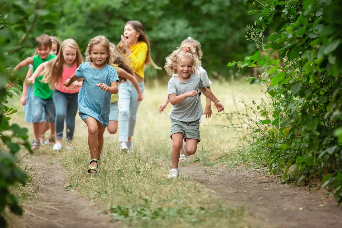 Children running and exploring outdoors during Uxbridge Fair scavenger hunt activities