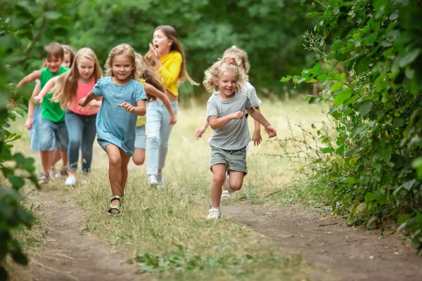 Children running and exploring outdoors during Uxbridge Fair scavenger hunt activities