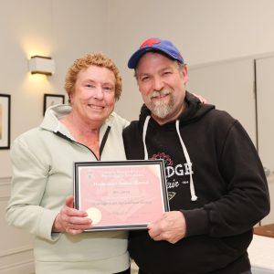 Bev Latva receives Meritorious Service Award certificate from Rob Ashton at Uxbridge Fair AGM